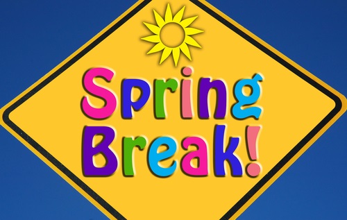 Image of a street sign in yellow with a picture of the sun at the top with the words Spring Break in multicolored letters.