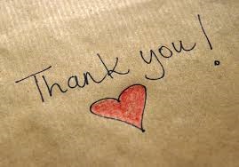 Piece of brown butcher paper with thank you written on it with a red heart.