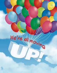 Colorful balloons float against a blue sky, with the text "We're all moving UP!" prominently displayed.
