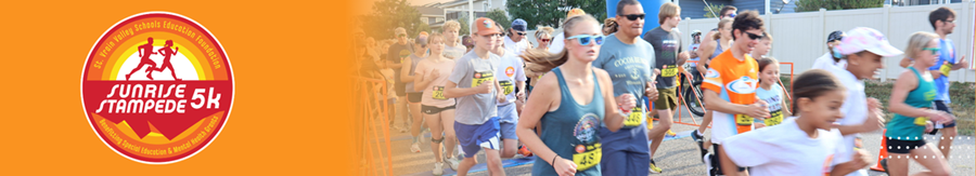A group of runners participating in the Sunrise Stampede 5K, wearing race numbers and enjoying the event.